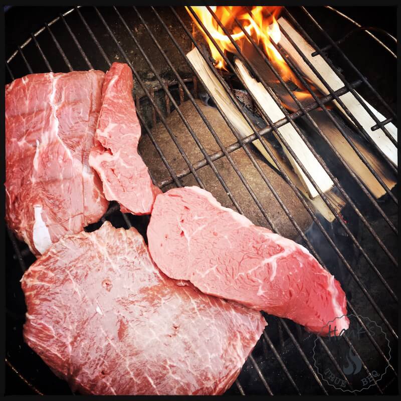 Flat Iron Steak (the two large pieces to the left) on the grill