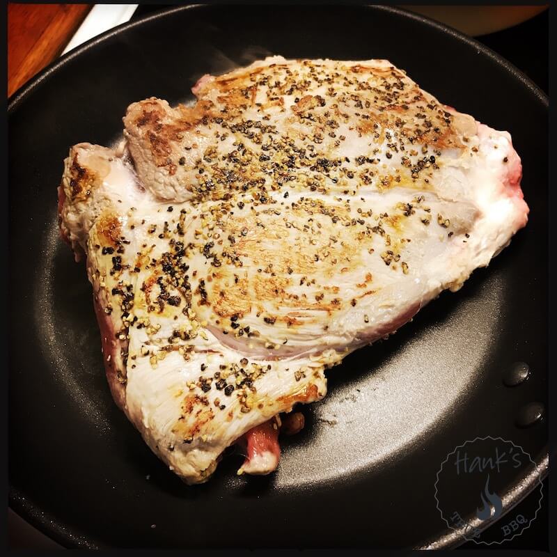 Lamb roast being browned in a frying pan